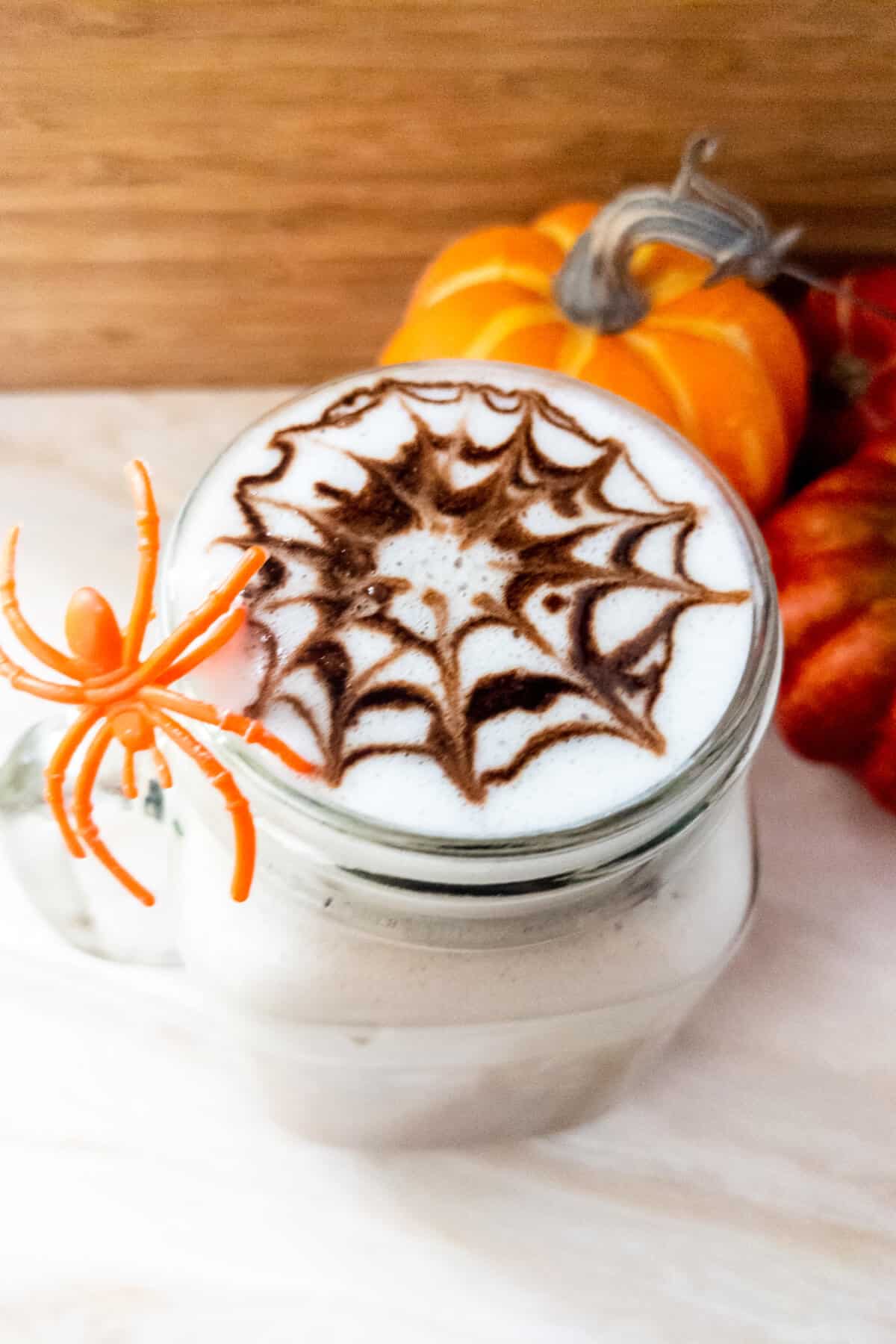 Café mocha topped with chocolate spider web.