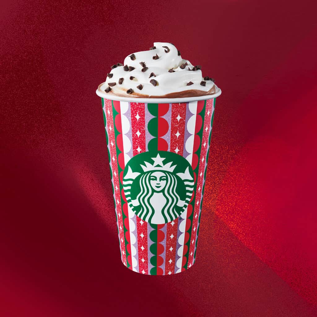 Starbucks red cup with whipped cream and chocolate chips on top